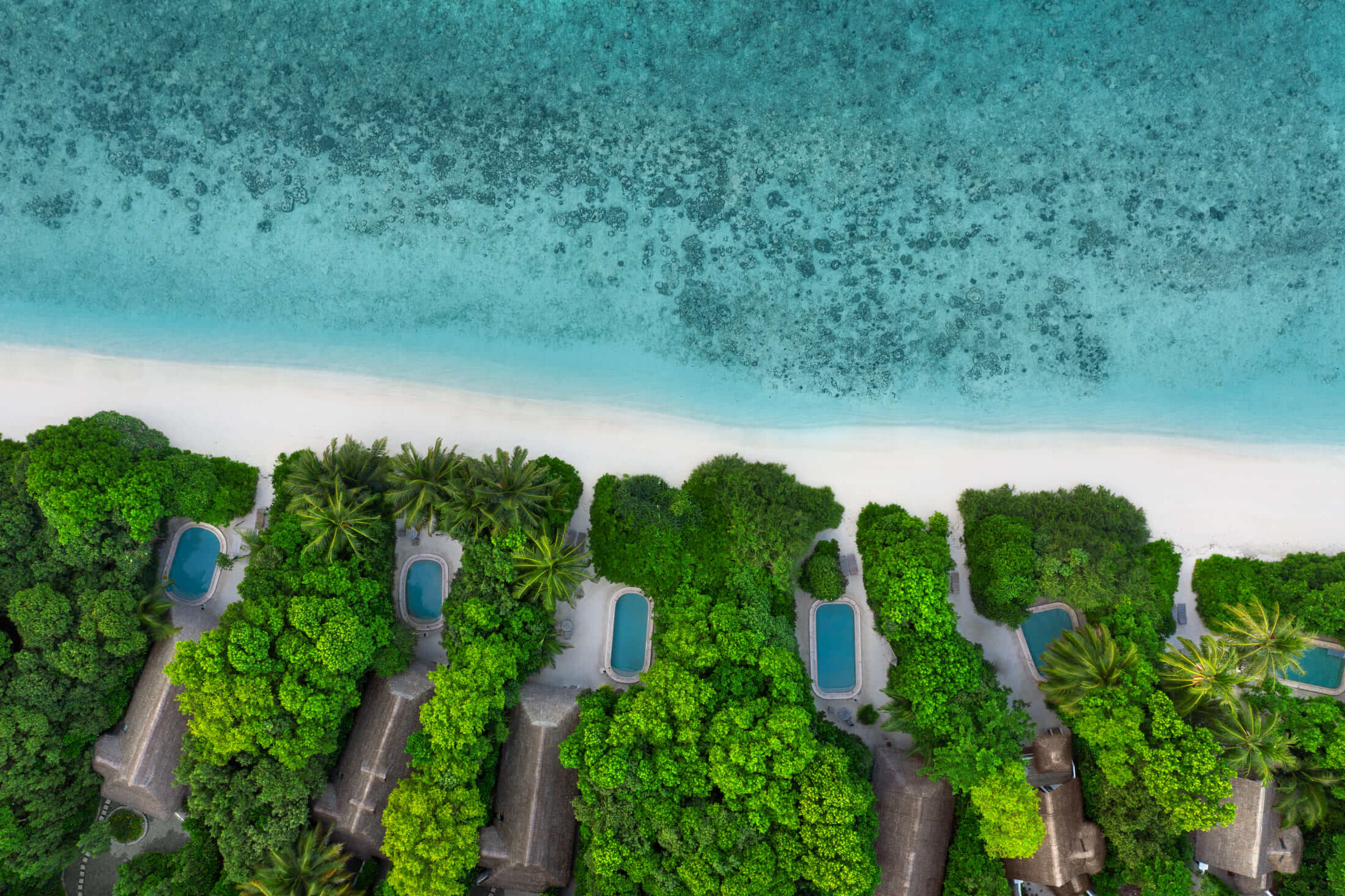 aerial view of beachside villas at Soneva Fushi Maldives